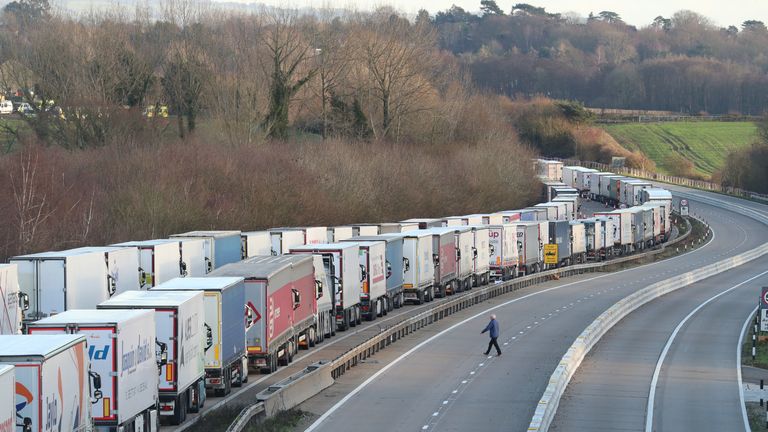 Freight lorries lined up on the M20 near Ashford, Kent, where hundreds of travellers are spending Christmas Day as they wait to resume their journey to the Port of Dover and across The Channel now that the borders with France have reopened.