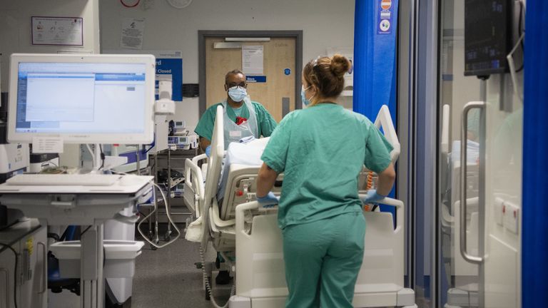 Staff nurses transfer a patient through the Emergency Department at St George's Hospital in Tooting, south-west London.