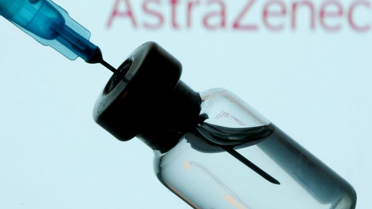 A vial and sryinge are seen in front of a displayed AstraZeneca logo in this illustration taken January 11, 2021. REUTERS/Dado Ruvic/Illustration/File Photo