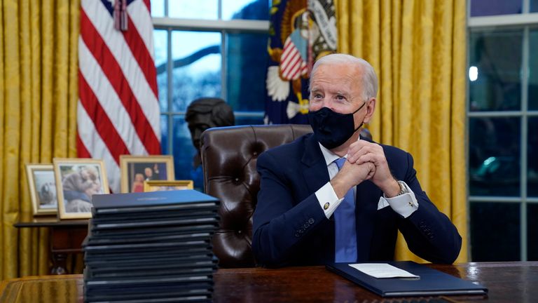 President Joe Biden waits to sign his first executive order in the Oval Office of the White House in Washington. As one of his first acts, Biden offered a sweeping immigration overhaul that would provide a path to U.S. citizenship for the estimated 11 million people who are in the United States illegally. It would also codify provisions wiping out some of President Donald Trump&#39;s signature hard-line policies, including trying to end existing, protected legal status for many immigrants brought