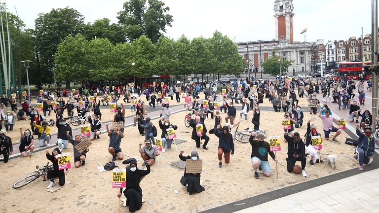 PA REVIEW OF THE YEAR 2020 File photo dated 03/06/20 of people take a knee during a Black Lives Matter protest rally at Windrush Square, Brixton, south, London, in memory of George Floyd who was killed on May 25 while in police custody in the US city of Minneapolis.

