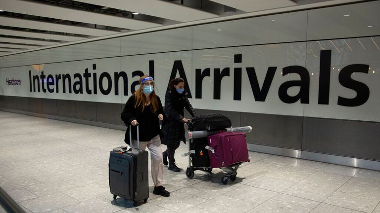 Passengers arrive in the arrivals area at Heathrow Airport, in London, Monday, Jan. 18, 2021. The UK closed all travel corridors from Monday morning to protect against the coronavirus with travellers entering the country from overseas required to have proof of a negative COVID-19 test. (AP Photo/Matt Dunham).            