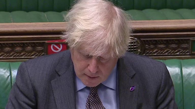 Boris Johnson looks down while the Labour leader asks him why over 100,000 have died from COVID-19 in the UK
