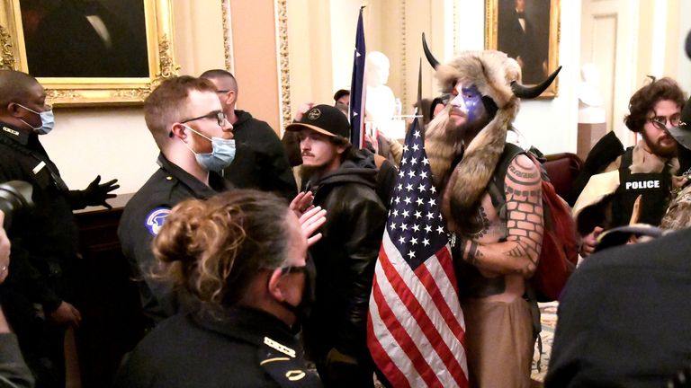Police confront supporters of President Donald Trump inside the Capitol building