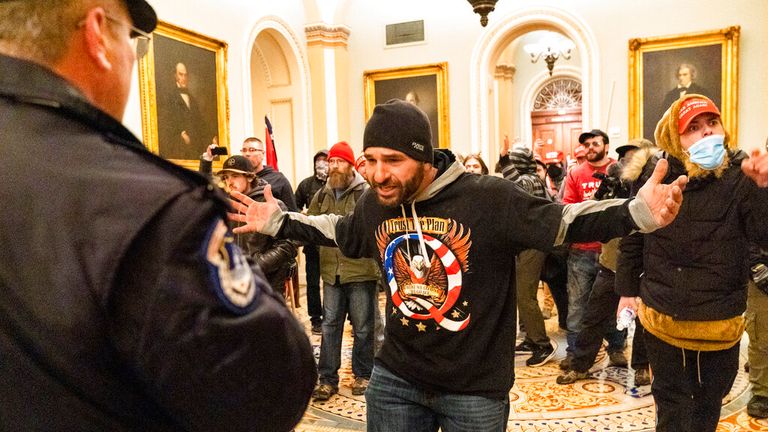 Supporters of President Donald Trump are confronted by Capitol Police officers outside the Senate Chamber at the Capitol