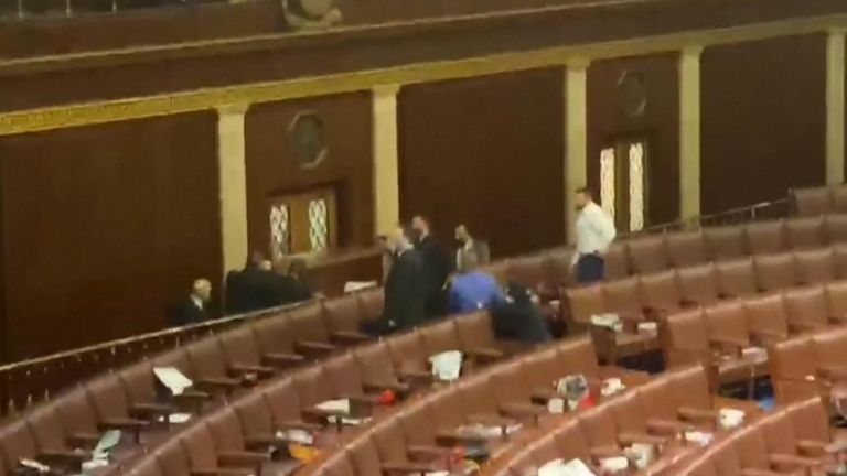 Video images from inside the U.S. Capitol on Wednesday (January 6) showed people on the House floor standing near a window with guns drawn. The identity of the men holding the guns was unclear. Unidentified voices could be heard off camera asking people to get down.
