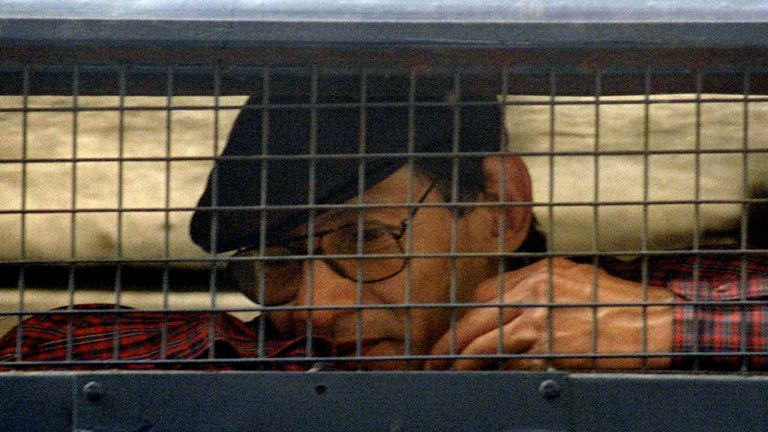 Renowned criminal Charles Sobhraj, 52, sits inside a police van outside a New Delhi court February 24. India formally ordered that Sobhraj, who has faced charges of murder, robbery and jailbreak, to be deported to his native France and barred his re-entry into India.