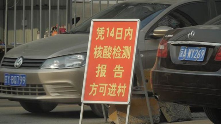 A sign in Beijing telling people they cannot enter the area unless they have a negative COVID test