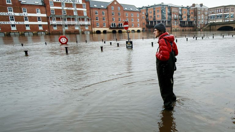 A person stands in flood water in York as Storm Christoph is set to bring widespread flooding