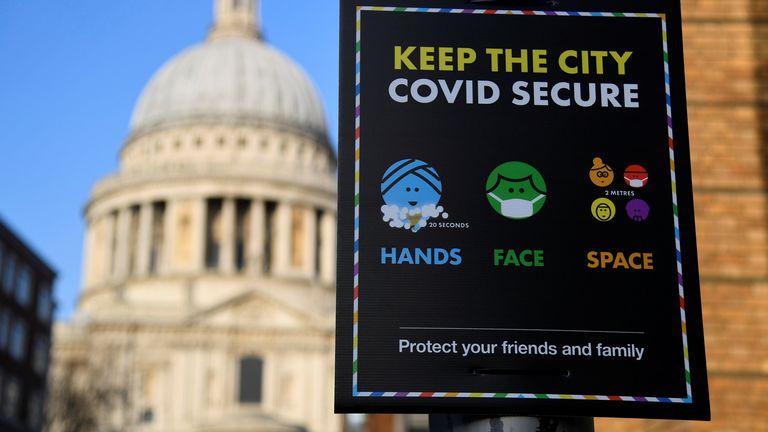 A public health information sign is seen with St. Paul&#39;s Cathedral seen behind amidst a lockdown during the spread of the coronavirus disease (COVID-19) pandemic, London, Britain, January 7, 2021. REUTERS/Toby Melville