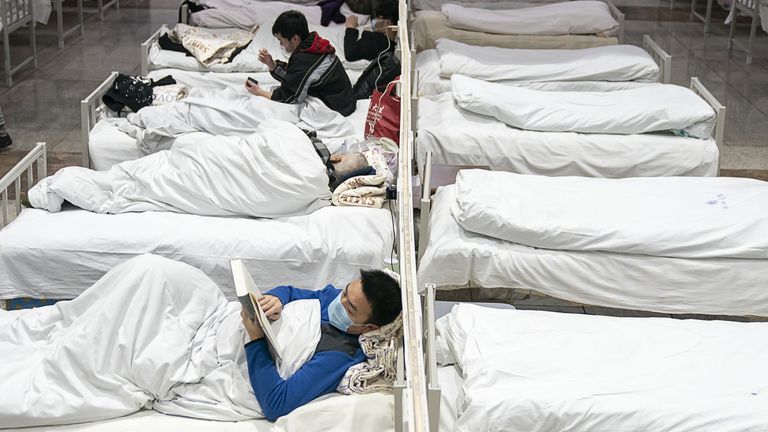 (210106) -- BEIJING, Jan. 6, 2021 (Xinhua) -- Patients infected with COVID-19 are seen at the Jianghan makeshift hospital in Wuhan, central China&#39;s Hubei Province, Feb. 5, 2020. The first makeshift hospital converted from an exhibition center in Wuhan city began accepting patients with mild symptoms at 10 p.m., Feb. 5, 2020. (Xinhua/Xiong Qi)