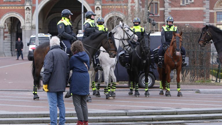 Police patrol the protests in Amsterdam. Pic: AP images