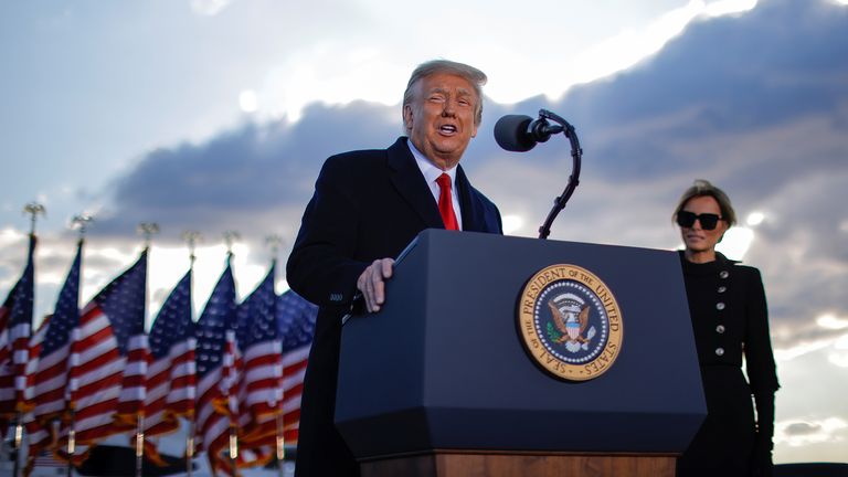 U.S. President Donald Trump speaks next to first lady Melania Trump as he departs from the Joint Base Andrews, Maryland, U.S., January 20, 2021. REUTERS/Carlos Barria