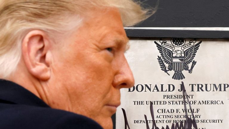 FILE PHOTO: U.S. President Donald Trump signs a plaque placed at the U.S.-Mexico border wall during his visit, in Alamo, Texas, U.S., January 12, 2021. REUTERS/Carlos Barria/File Photo
