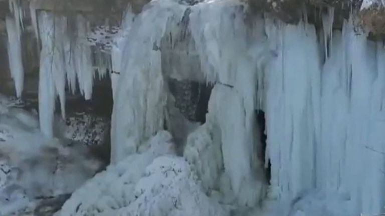 Waterfall freezes in US cold snap