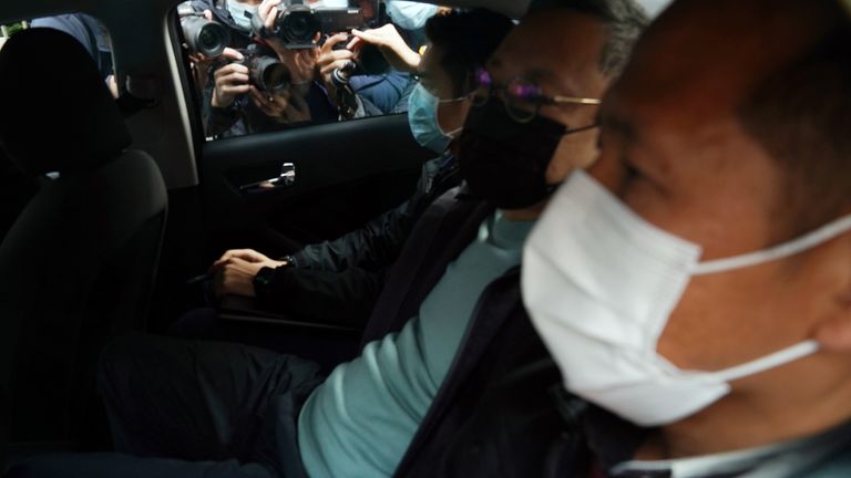 Pro-democracy activist Benny Tai (2nd R) is taken to a police station in Hong Kong,