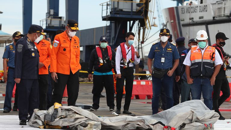 Rescuers inspect debris found in the waters around the location where a Sriwijaya Air passenger jet has lost contact with air traffic controllers shortly after the takeoff, at the search and rescue command center at Tanjung Priok Port in Jakarta, Indonesia, Sunday, Jan. 10, 2021. The Boeing 737-500 took off from Jakarta for Pontianak, the capital of West Kalimantan province on Indonesia&#39;s Borneo island, and lost contact with the control tower a few moments later. (AP Photo/Achmad Ibrahim)