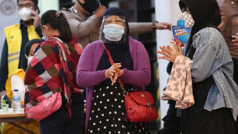 Relatives of passengers arrive at a crisis center set up following a report that a Sriwijaya Air passenger jet has lost contact with air traffic controllers shortly after take off, at Soekarno-Hatta International Airport in Tangerang, Indonesia,Saturday, Jan. 9, 2021. The Boeing 737-500 took off from Jakarta and lost contact with the control tower a few moments later. (AP Photo/Tatan Syuflana)