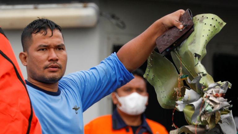 An Indonesian Navy diver with some plane debris