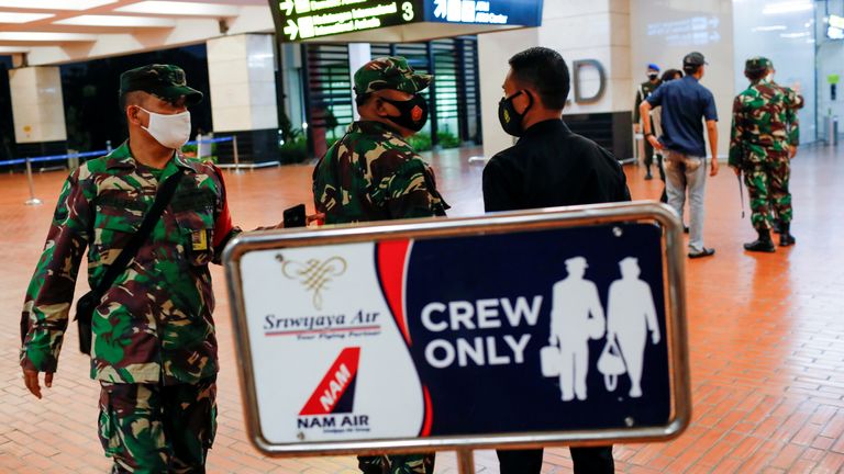 Indonesian soldiers are seen at Soekarno-Hatta International Airport after Sriwijaya Air plane flight SJ182 with more than 50 people on board lost contact after taking off