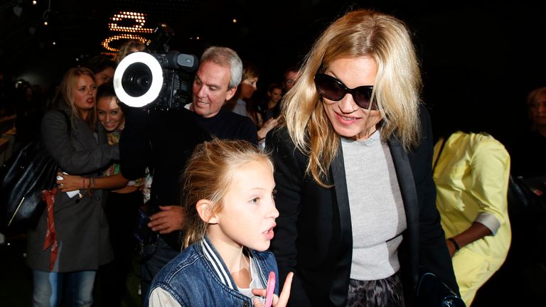 British model Kate Moss leaves the Topshop Unique Spring/Summer 2014 collection with her daughter Lila Grace during London Fashion Week