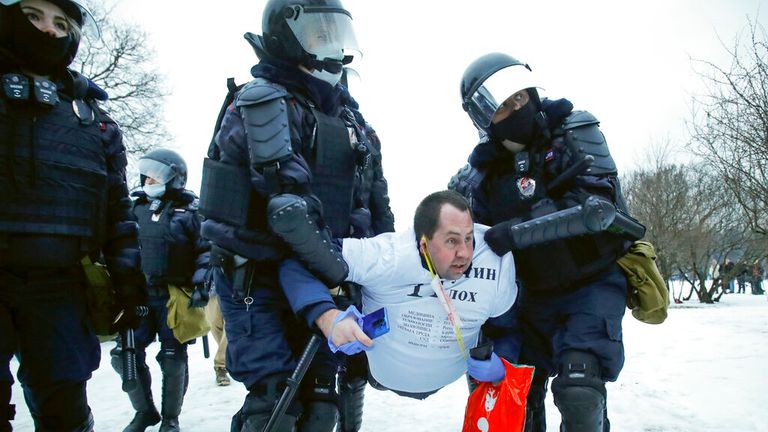 A man is carried away by armoured police