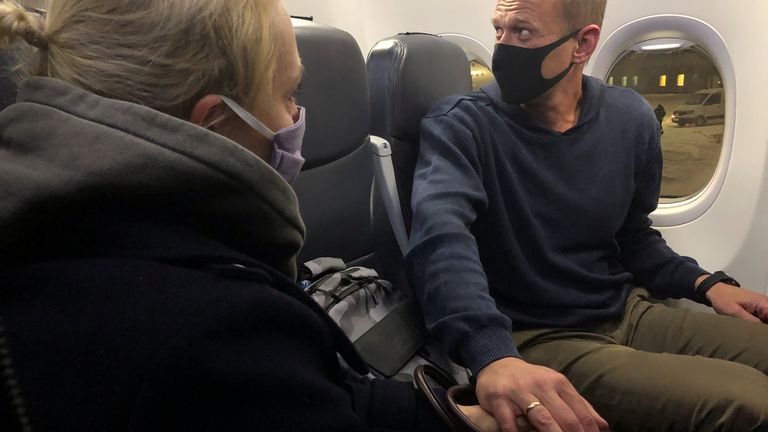 Russian opposition leader Alexei Navalny and his wife Yulia Navalnaya are seen on board a plane after landing at Sheremetyevo airport in Moscow, Russia January 17, 2021. REUTERS/Polina Ivanova