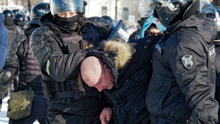 Police detain a man in in Khabarovsk, Russia, during a protest against the jailing of Alexei Navalny 