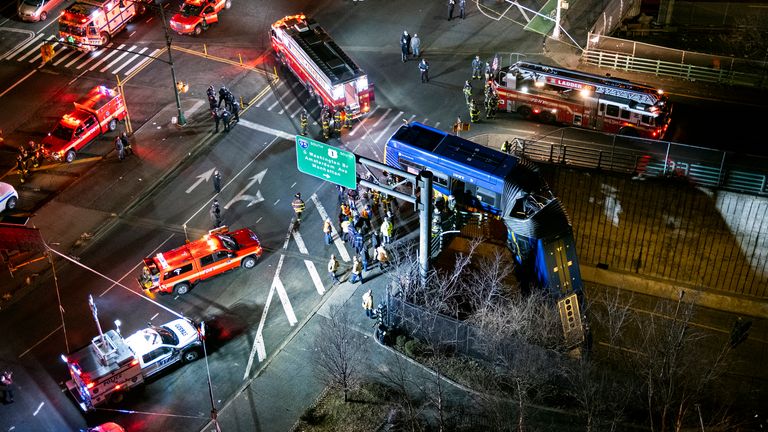 A bus in New York City careened off a road in the Bronx neighborhood of New York and was left dangling from an overpass Friday, Jan. 15, 2021, after a crash late Thursday that left the driver in serious condition, police said. (AP Photo/Craig Ruttle)