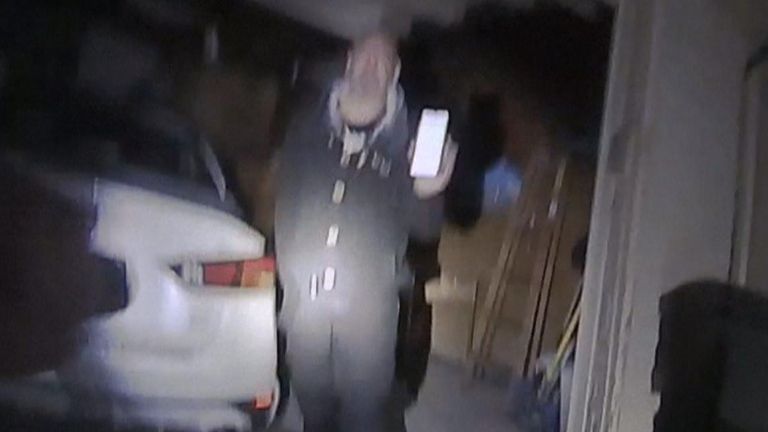 Andre Hill can be seen holding a mobile phone in his left hand before he was shot