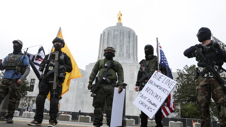 Armed protesters outside the Oregon state capitol - but protests in the US this weekend were small and trouble-free