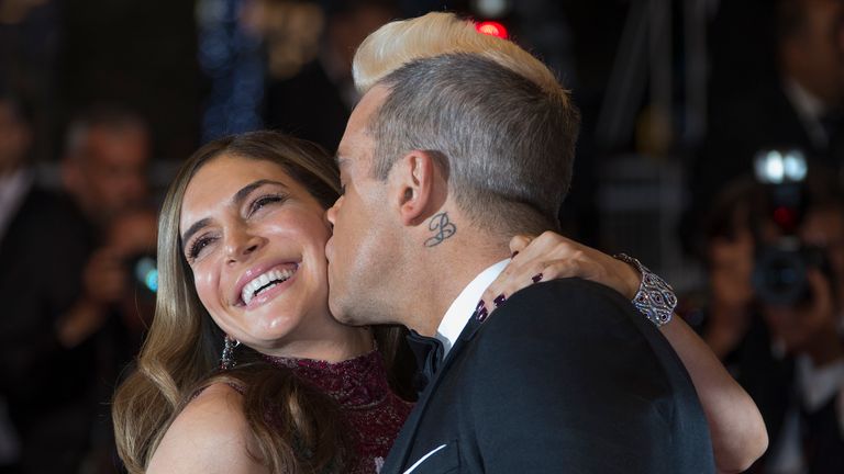 Singer Robbie Williams (R) kisses his wife Ayda Field as they pose on the red carpet for the screening of the film "The Sea of Trees" in competition at the 68th Cannes Film Festival in Cannes, southern France, May 16, 2015. REUTERS/Yves Herman TPX IMAGES OF THE DAY
