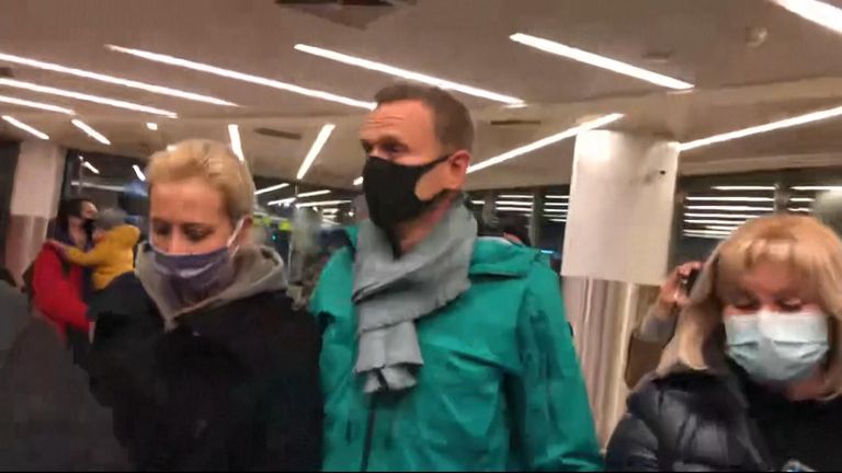 Poisoned Putin critic Alexei Navalny arrives at Moscow airport.