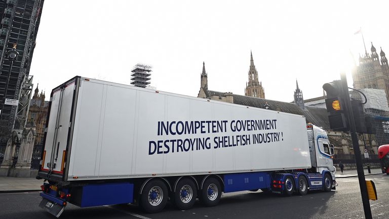 A lorry with a sign in protest against post-Brexit bureaucracy that hinders exports to the European Union, drives at the Parliament Square in London, Britain, 18 January 2021. REUTERS/Hannah McKay