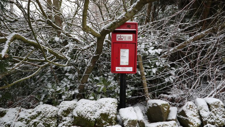 A postbox among snow-covered trees in Hollow Meadows, near Sheffield.

