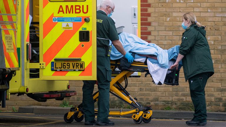 Paramedics transfer a patient from an ambulance into Southend Hospital in Essex