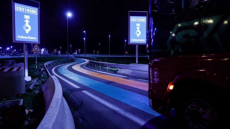 A truck drives over green and orange lines on the road that are part of the new customs infrastructure for entry into France, in Calais, France, January 1, 2021. REUTERS/Pascal Rossignol