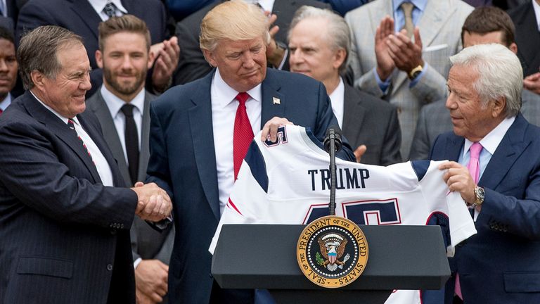 President Donald Trump is presented with a New England Patriots jersey by Patriots head coach Bill Belichick, left, in 2017