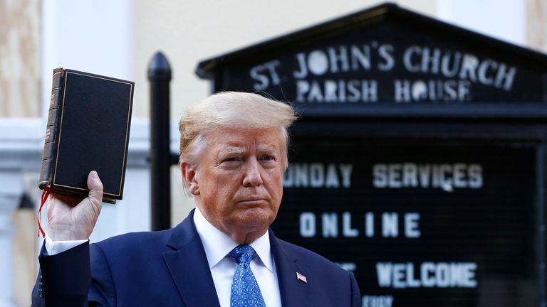 President Donald Trump holds a Bible as he visits outside St. John's Church across Lafayette Park from the White House Monday, June 1, 2020, in Washington. Part of the church was set on fire during protests 
