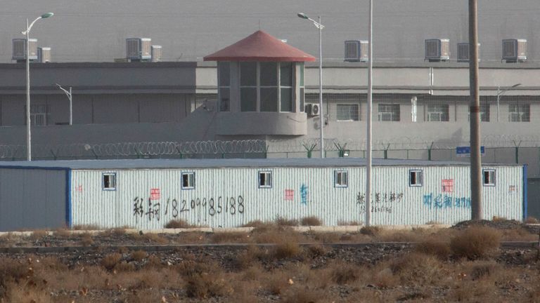 A guard tower and barbed wire fences at a facility in Xinjiang, China