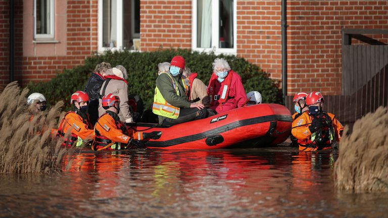 Residents of a care home are evacuated after the river Weaver burst banks in Northwich, Britain, January 21, 2021. REUTERS/Molly Darlington