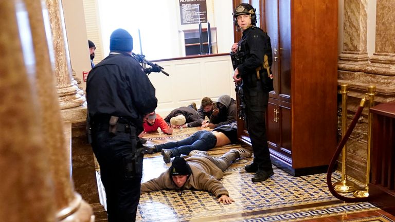 U.S. Capitol Police hold protesters at gun-point near the House Chamber inside the U.S. Capitol on Wednesday, Jan. 6, 2021, in Washington. (AP Photo/Andrew Harnik)