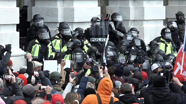 Riot police clash with protesters outside Capitol building
