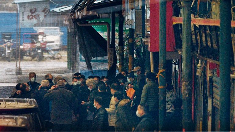 Members of the World Health Organization's team investigating the origins of the coronavirus pandemic arrive at the Huanan seafood wholesale market in Wuhan, China, on Jan. 31, 2021. (Kyodo via AP Images) ==Kyodo