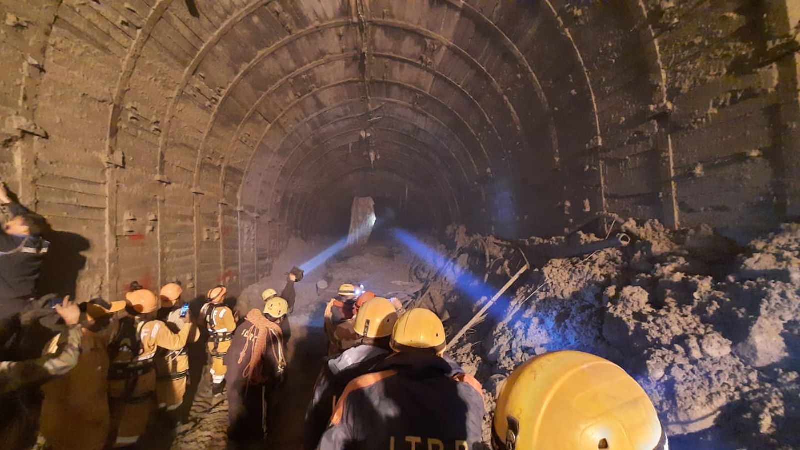 India Rescuers try to reach workers trapped in tunnel as relatives