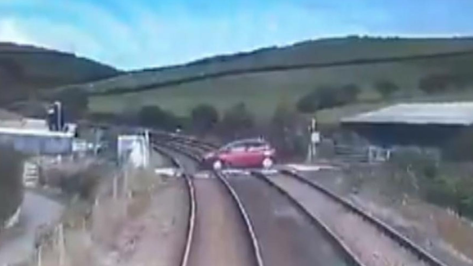 Near-miss as car drives over open level crossing | UK News | Sky News