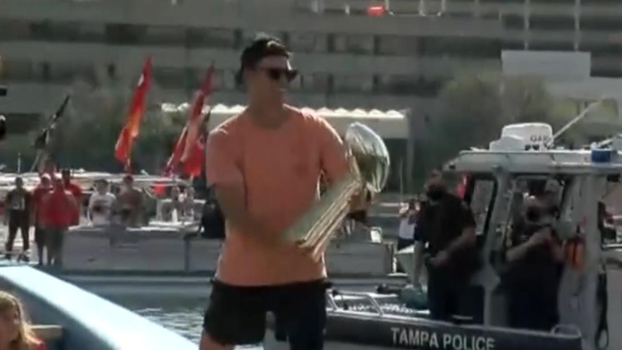 Tom Brady throws Super Bowl trophy to teammates on another boat during  parade, US News