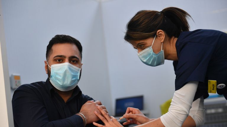 Pharmacist Josh Athwal (left) receives an injection of the Oxford/Astrazeneca coronavirus vaccine, administered by nurse Gurit Dhadday, at The Black Country Living Museum in Dudley. The open air museum, which has previously been used as a set for the BBC drama Peaky Blinders, is now being used as a covid vaccination centre. Picture date: Monday January 25, 2021.