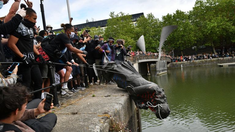 File photo dated 07/06/20 of pprotesters throwing the statue of Edward Colston into Bristol harbour during a Black Lives Matter protest rally. Four people will appear before Bristol Magistrates' Court on Monday charged with criminal damage following the toppling of a statue of slave trader Edward Colston in Bristol. Issue date: Monday January 25, 2021.