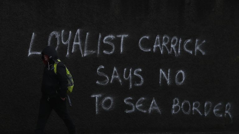 Graffiti on the A2 outside Carrickfergus in Belfast. The DUP has rejected claims it is whipping up tensions over Irish Sea trade in an effort to get Brexit's contentious Northern Ireland Protocol ditched. Physical inspections on goods entering Northern Ireland from Great Britain, which are required under the protocol, have been suspended amid threats and intimidation of staff. Picture date: Wednesday February 3, 2021.